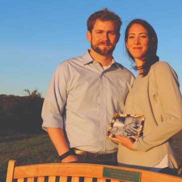 Aline and Josh Copp hold a photo of their daughter, Carter Copp