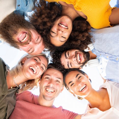 Diverse group of people in a circle smiling